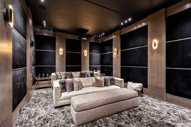 A luxurious home theater with modern decor, plush seating, and ambient lighting.